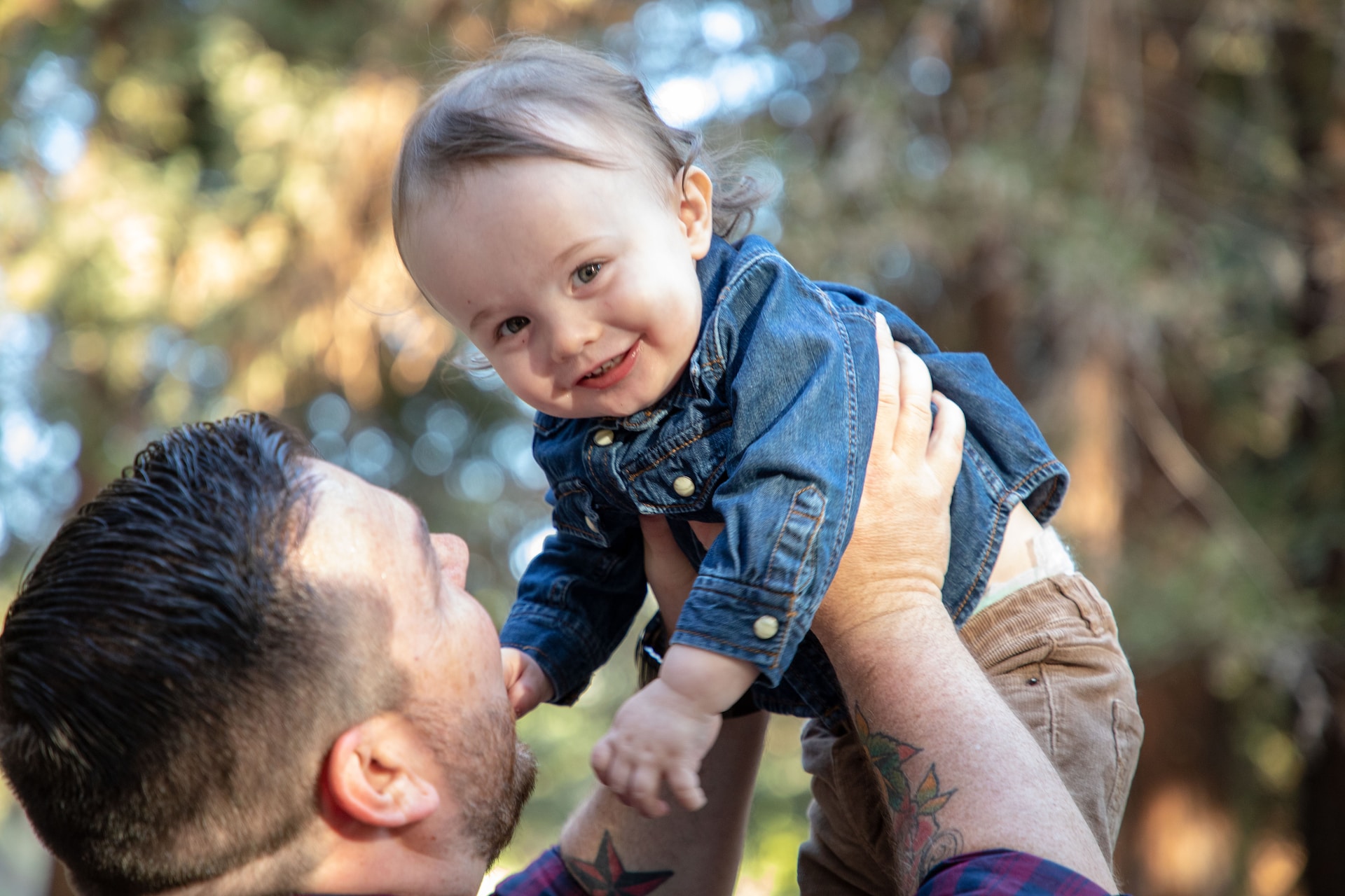 Father lifting baby in the air.